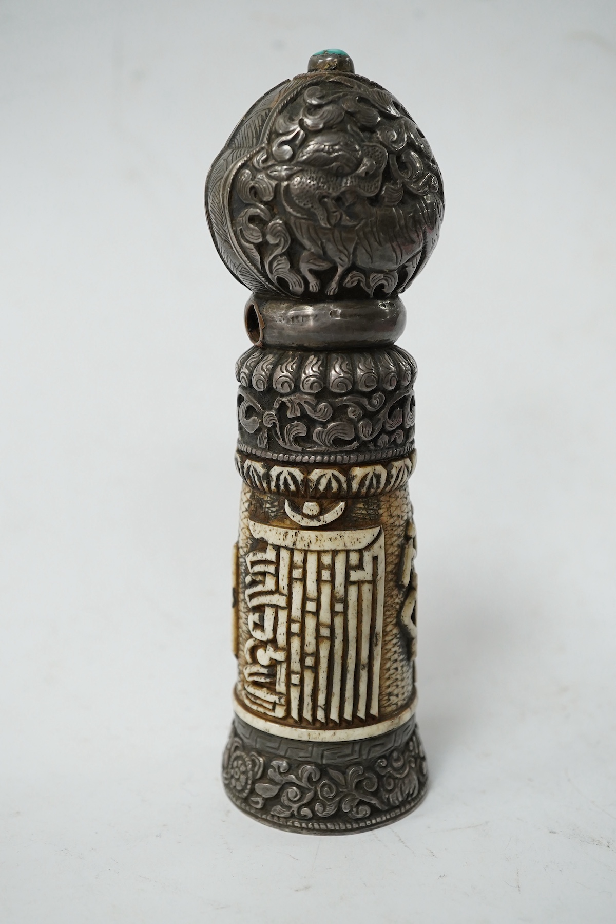 A Tibetan bone and repousse work seal, late 19th/early 20th century, 15cm high. Condition - fair
